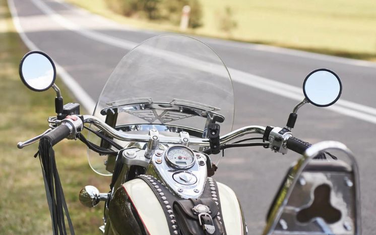 How frequently should I clean my motorcycle windshield?